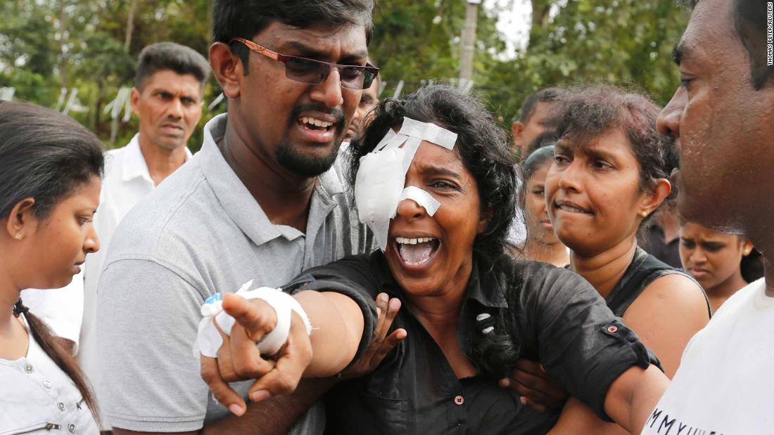 A woman who lost her husband and two children during the bombing at St Sebastian's Church yells towards the graves during a mass burial for victims at a cemetery near the church in Negombo, three days after a string of suicide bomb attacks on churches and luxury hotels across the island on Easter Sunday, in Sri Lanka April 24, 2019. REUTERS/Thomas Peter